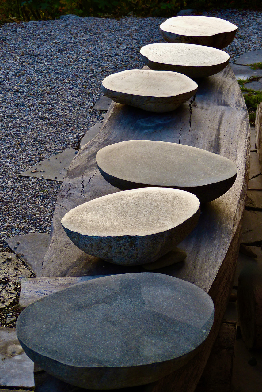 3  Bowl-shaped stones on boat-sharped table.  FOOD and NATURE